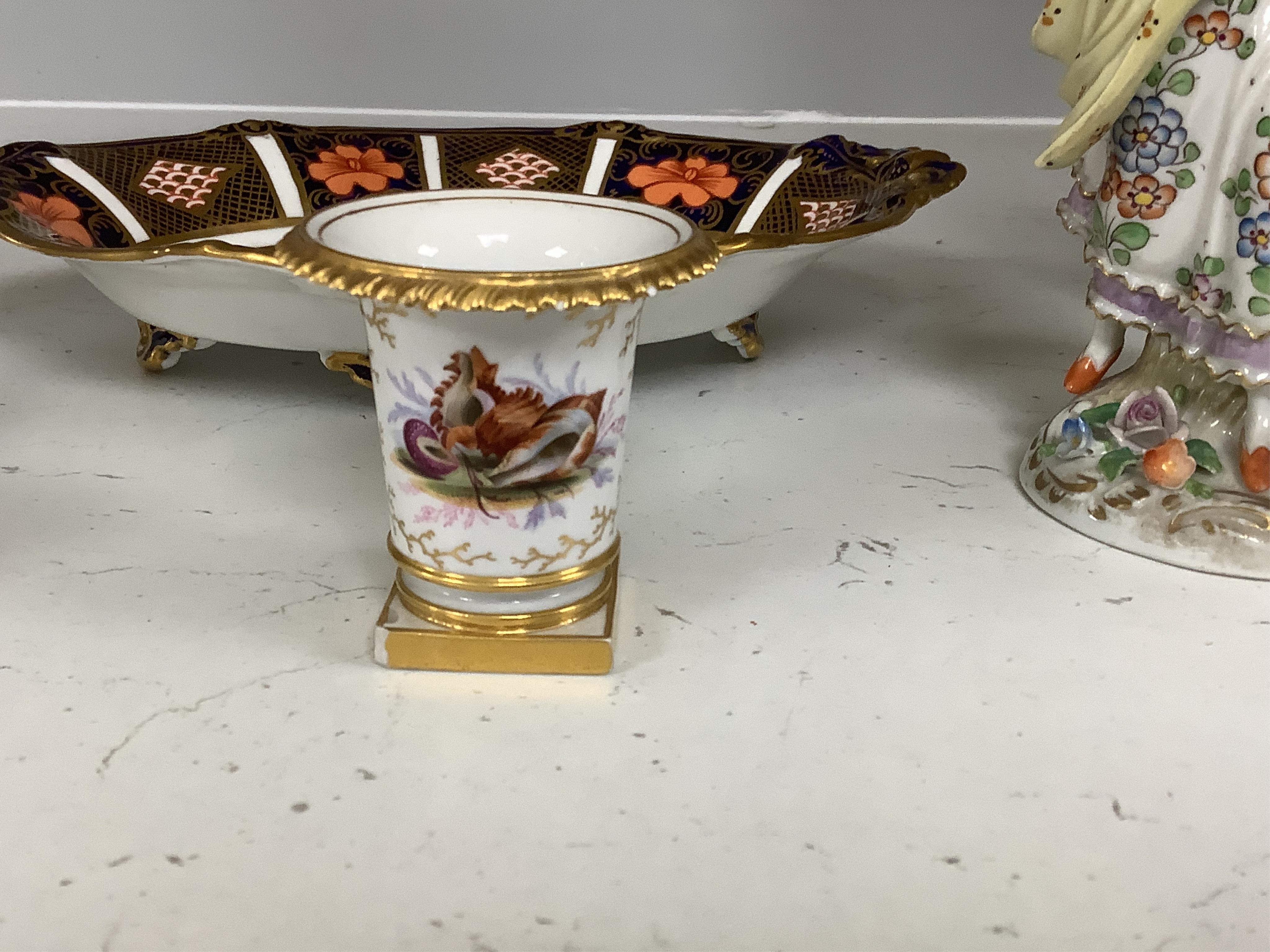 Four porcelain items - a small Flight Barr & Barr Worcester she’ll painted vase, a Derby mug, a Royal Crown Derby dish and a Sitzendorf figure, 16cm